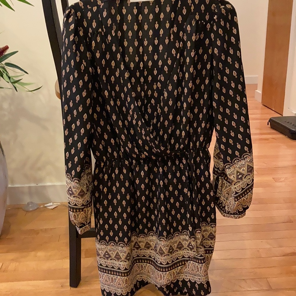 Long sleeved, knee length black patterned dress